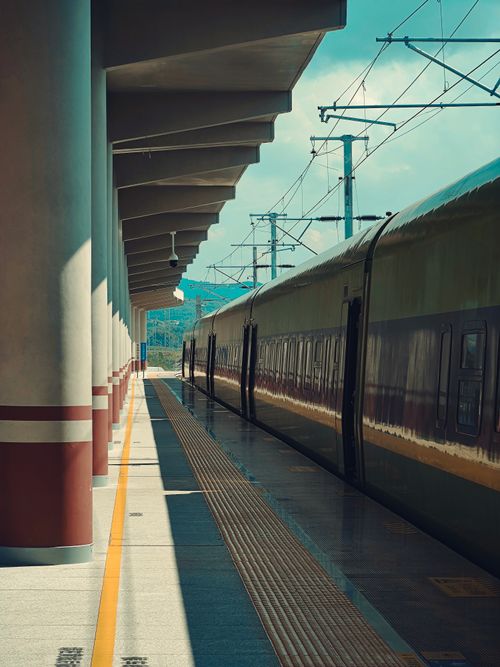 Free A sleek train on a platform at a sunny railway station in Xishuangbanna, Yunnan, China. Stock Photo