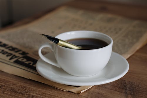 Close-up of a Cup of Black Coffee Standing on a Table 