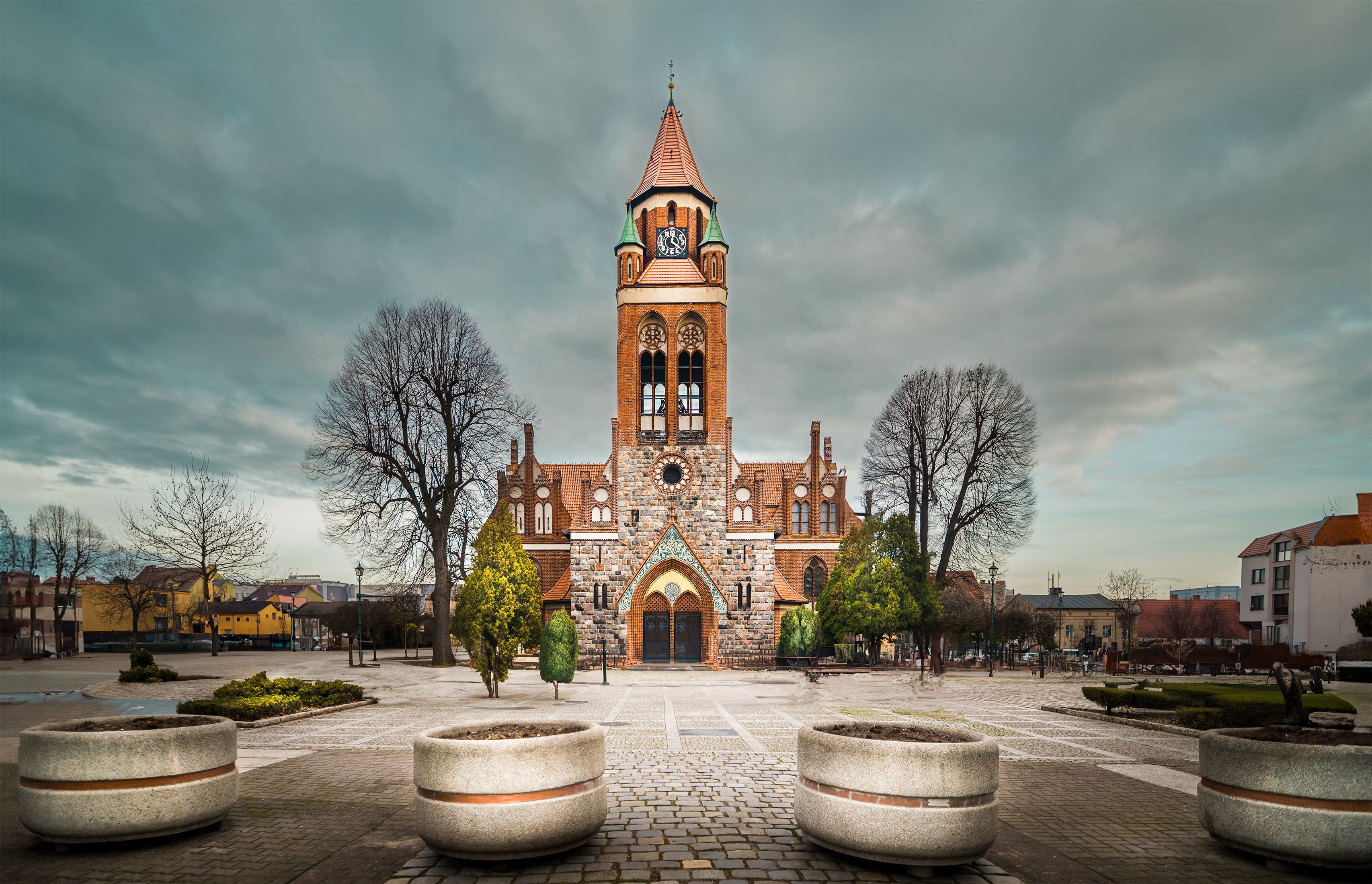 Scenic view of a historic church with a clock tower in Grodzisk Wielkopolski, Poland.