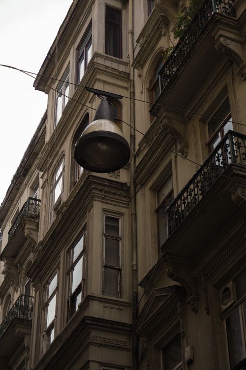 Free Charming view of classic urban architecture with a distinctive hanging lamp. Stock Photo