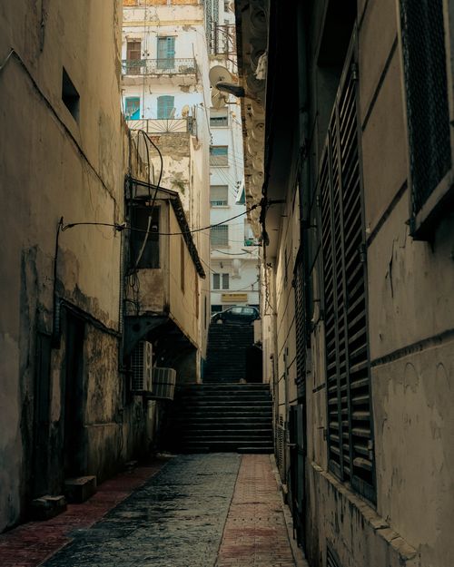 Free A quiet, narrow urban alley in Algiers with steps and old buildings. Stock Photo