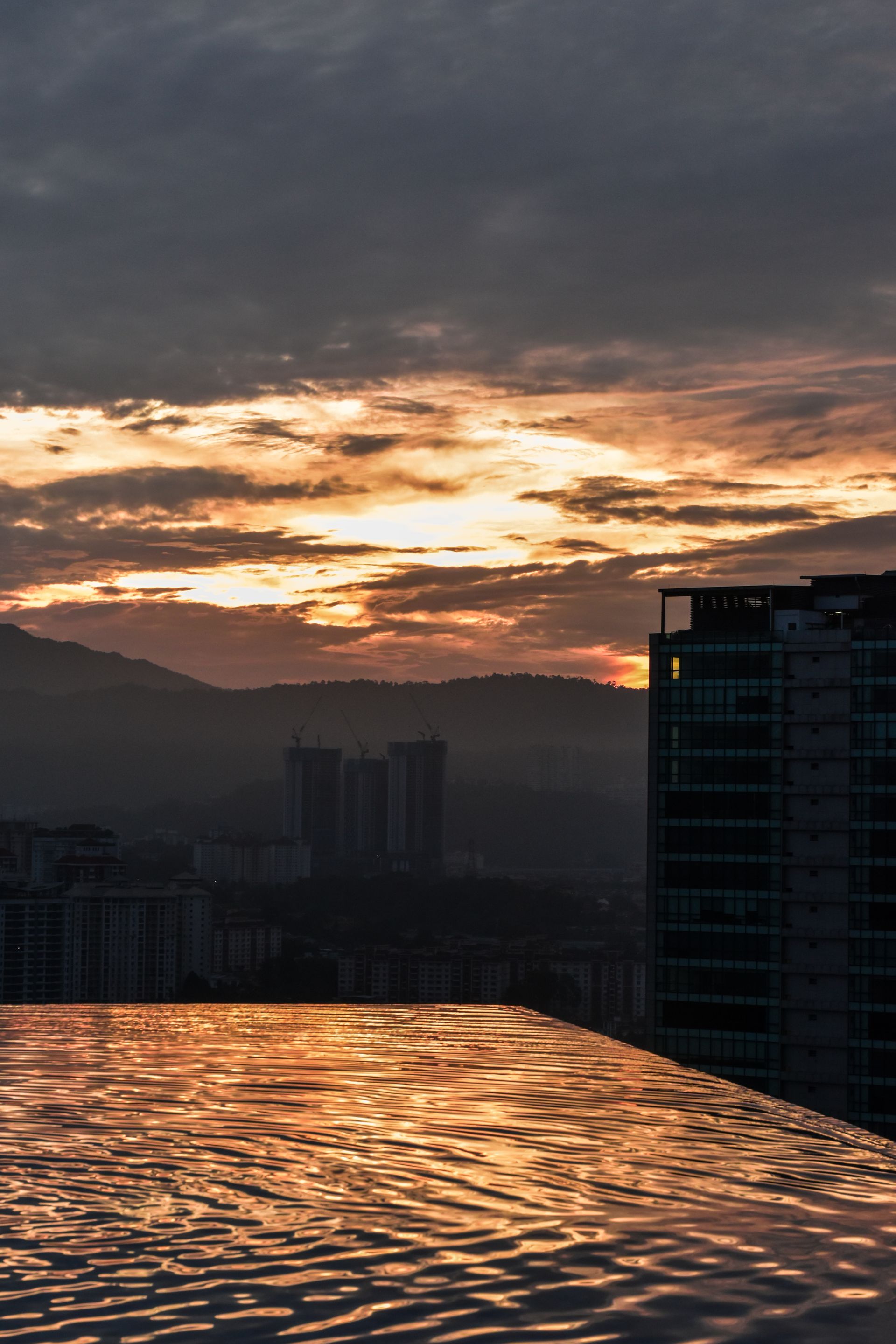 Rooftop infinity pool skyline at dusk