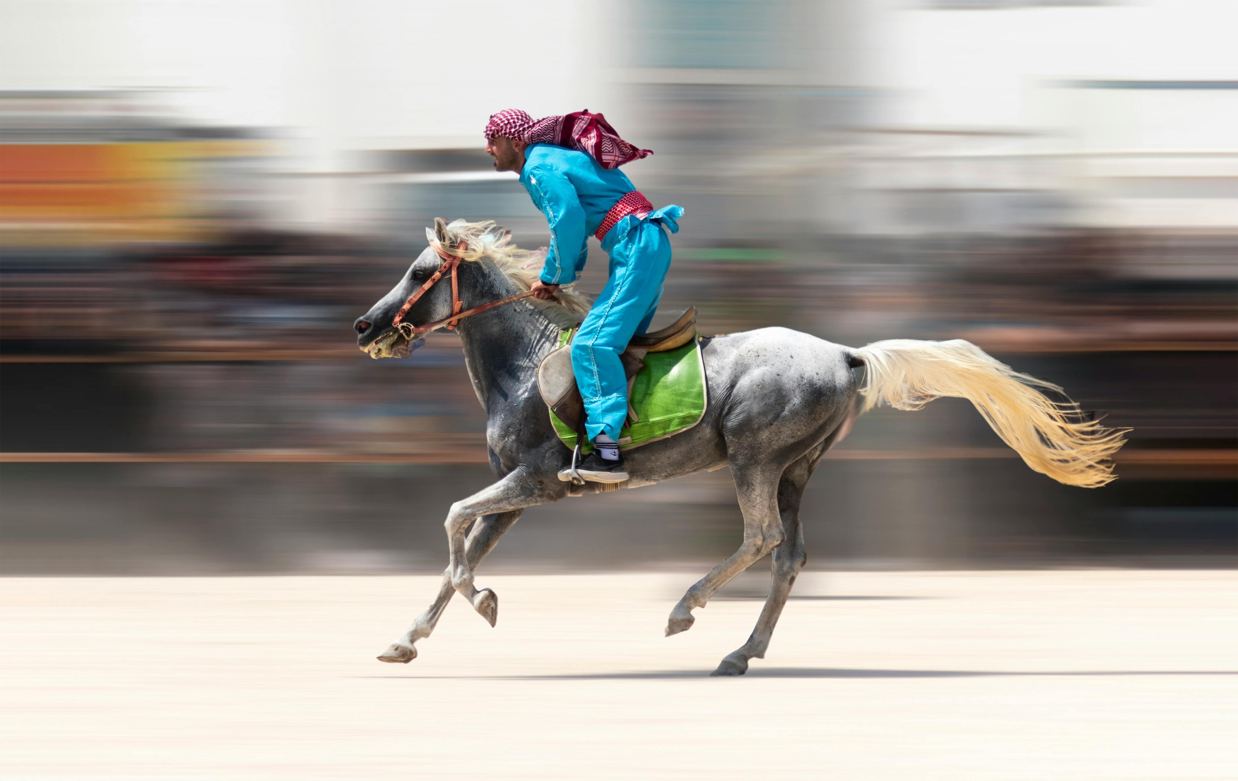 Exciting horse race captured at Kish, Iran showing a rider in full motion on a galloping horse.