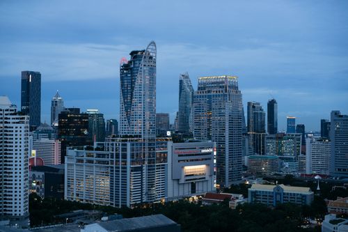 Free A breathtaking view of Bangkok's skyline showcasing modern skyscrapers under a dramatic twilight sky. Stock Photo