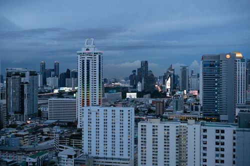 Free A dramatic view of Bangkok's skyline during dusk, showcasing vibrant skyscrapers. Stock Photo