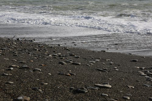 Gentle Sea Waves Rolling on a Beach with Gray Sand