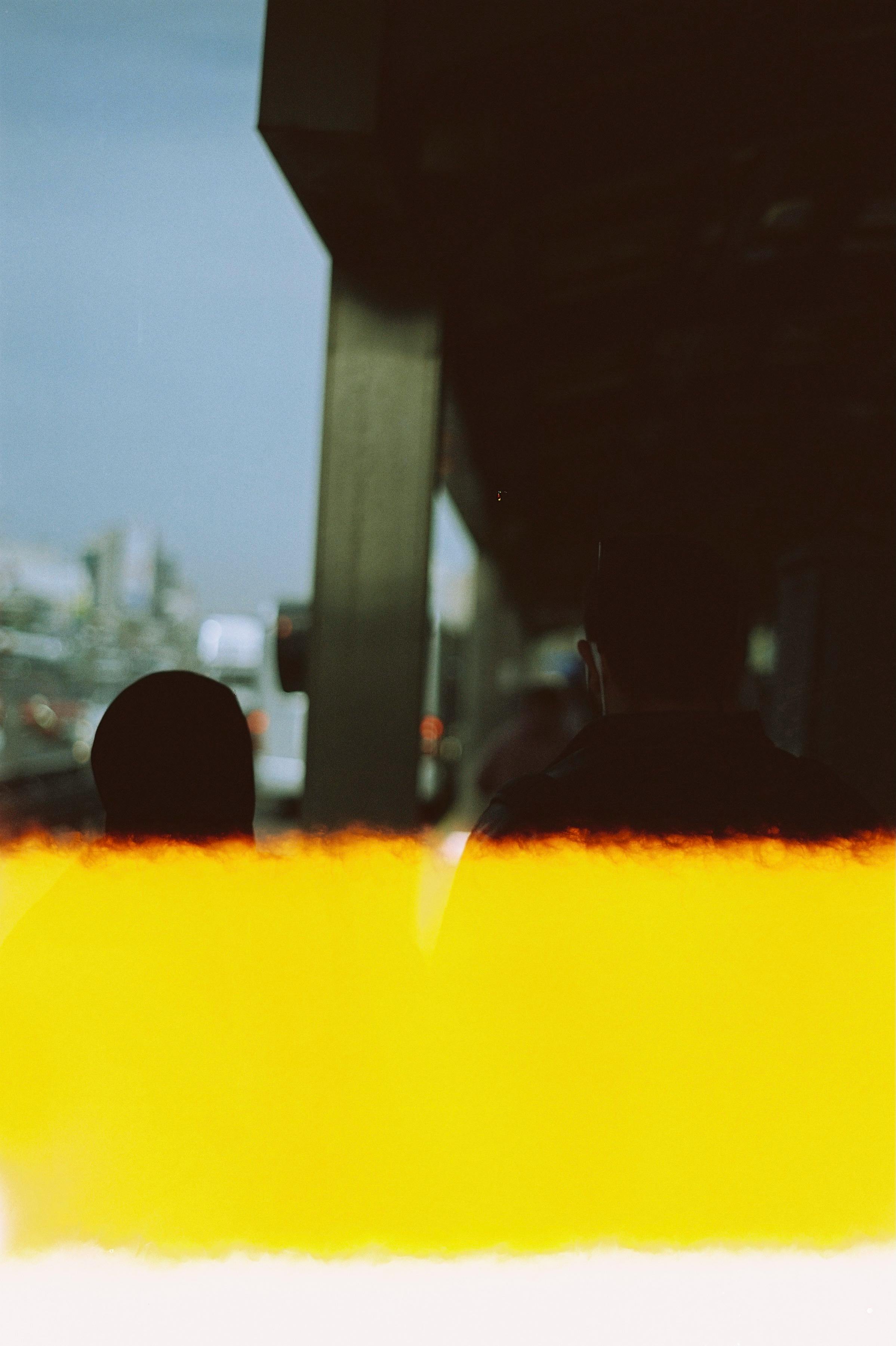 Free Film photography of two pedestrians silhouetted against a blue sky in Istanbul. Stock Photo