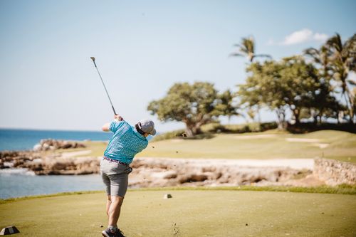 Free A man playing golf at a beautiful seaside course on a sunny day. Stock Photo