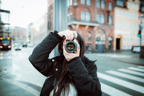 Woman Photographing in City
