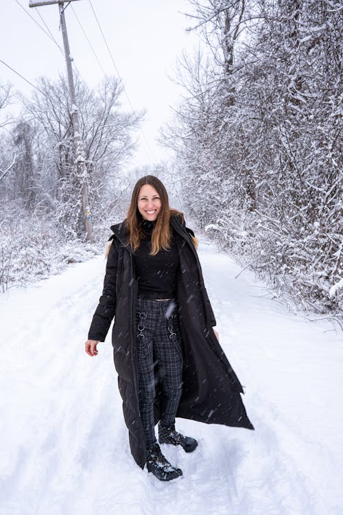 Smiling Woman in Jacket on Road in Forest