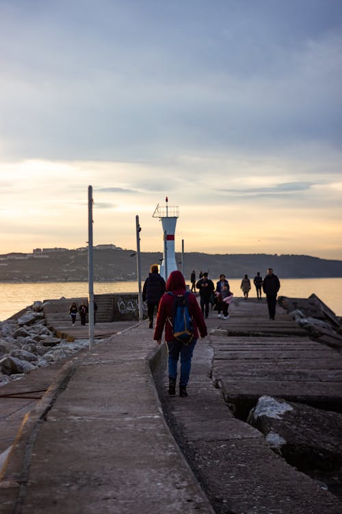 People walking on the jetty during sunset