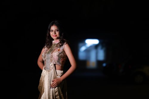 Free Portrait of a woman in traditional attire against a dark backdrop, exuding elegance. Stock Photo