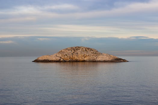 Tranquil scene of an isolated island surrounded by calm waters during a peaceful sunset in Şile, Istanbul.