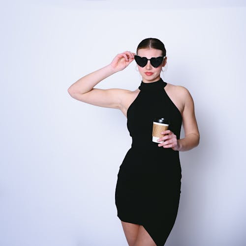 Model in Black Mini Posing with Disposable Cup