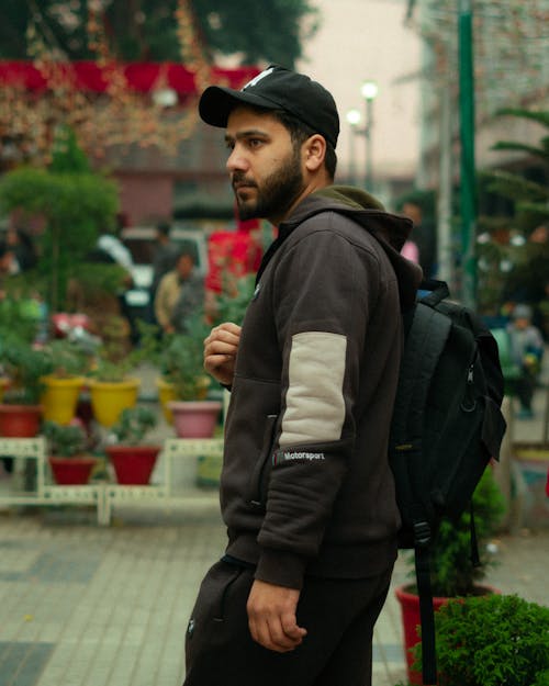 Man in Baseball Cap with Backpack