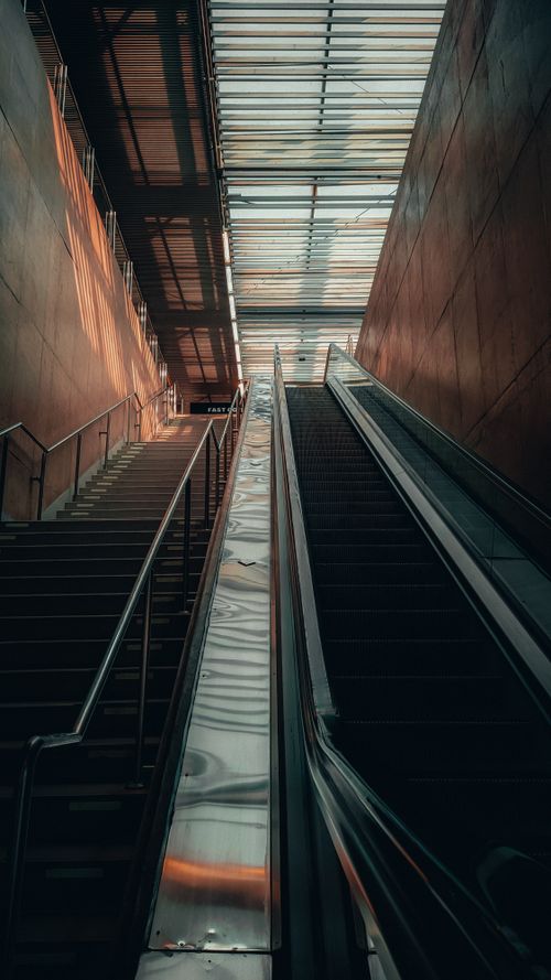 Free A sleek indoor escalator and staircase in a modern urban setting. Stock Photo