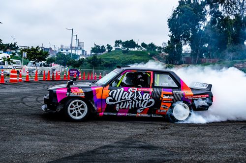 Free A colorful drift car creating smoke during a motorsport event on an open track. Stock Photo