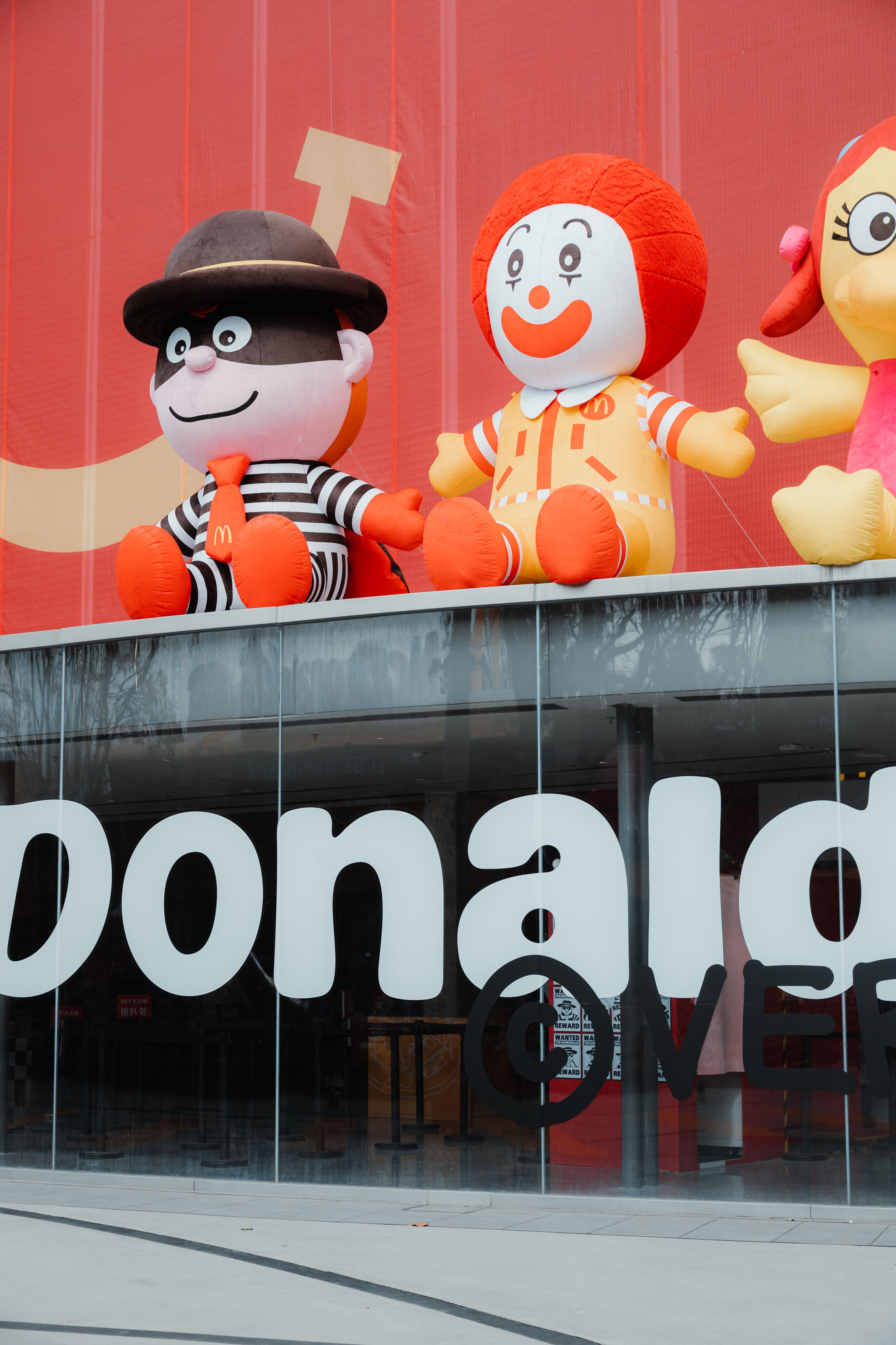 Vibrant cartoon characters above a famous fast food restaurant entrance.