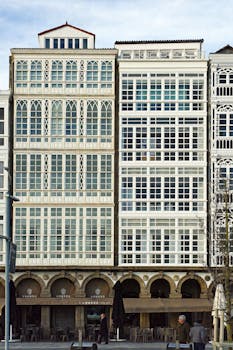 Vertical shot of ornate building facades in A Coruña, showcasing urban architecture.
