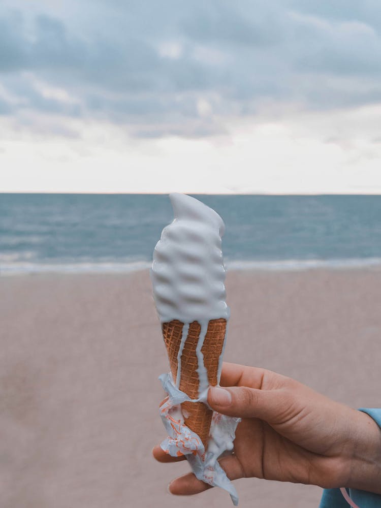 Person Holding Vanilla Ice Cream On Cone