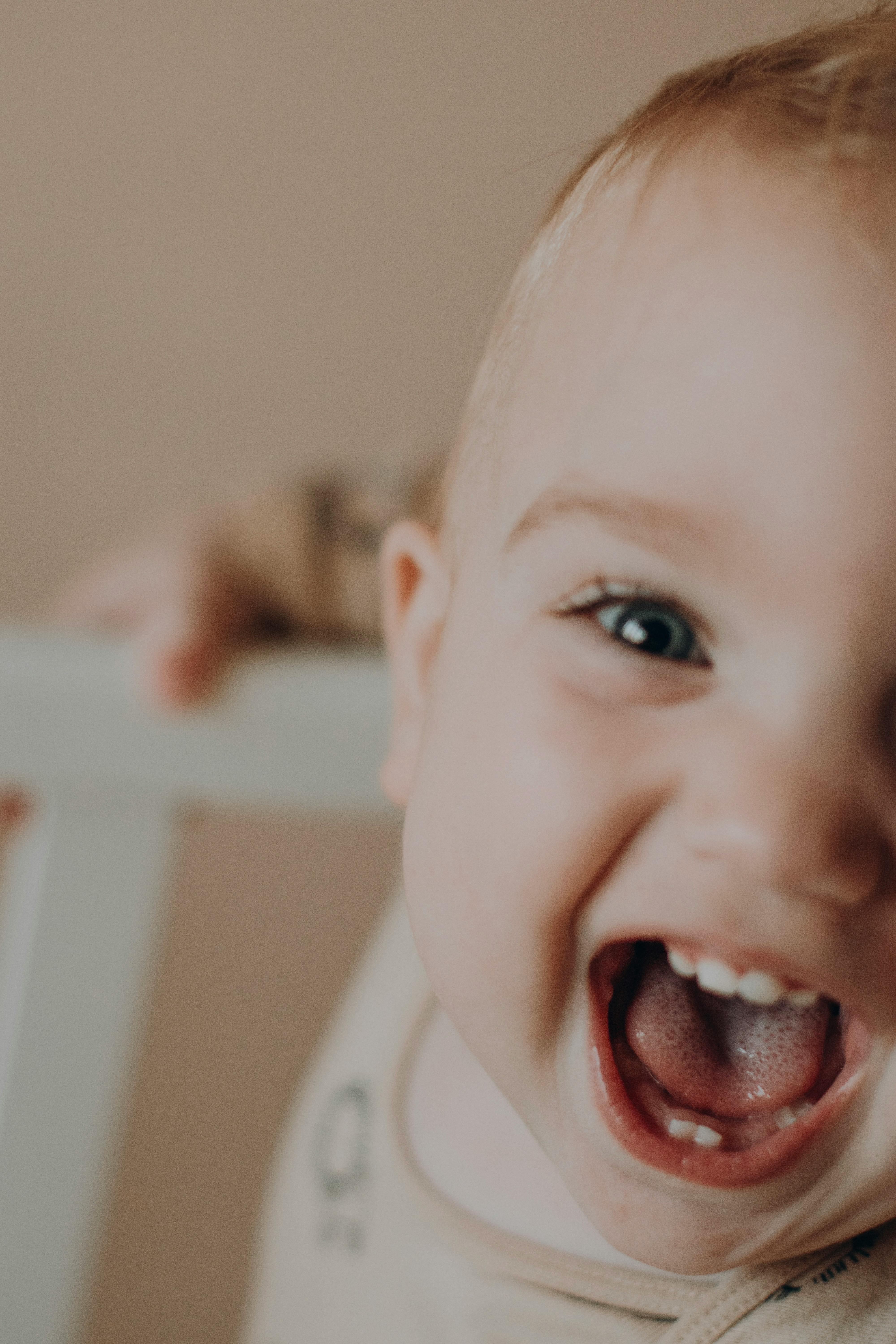 Adorable baby smiling widely in a heartwarming close-up shot.