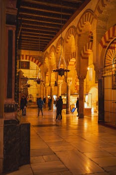 Explore the iconic arches and columns of the Mezquita-Catedral in Córdoba, Spain.