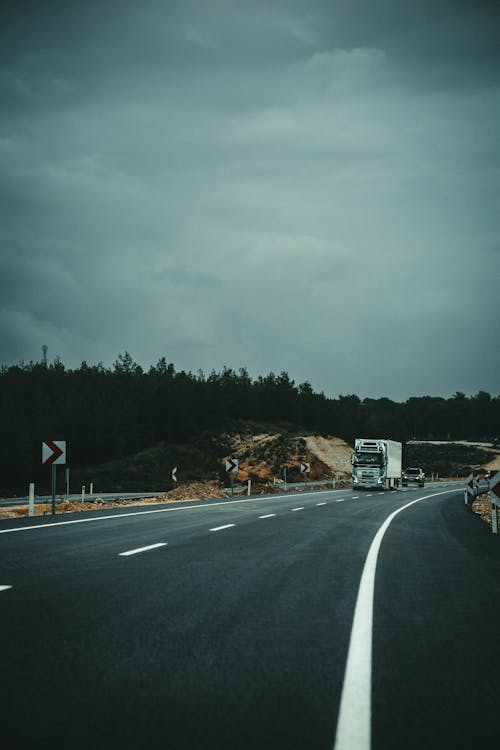 Truck and Car on Asphalt Road