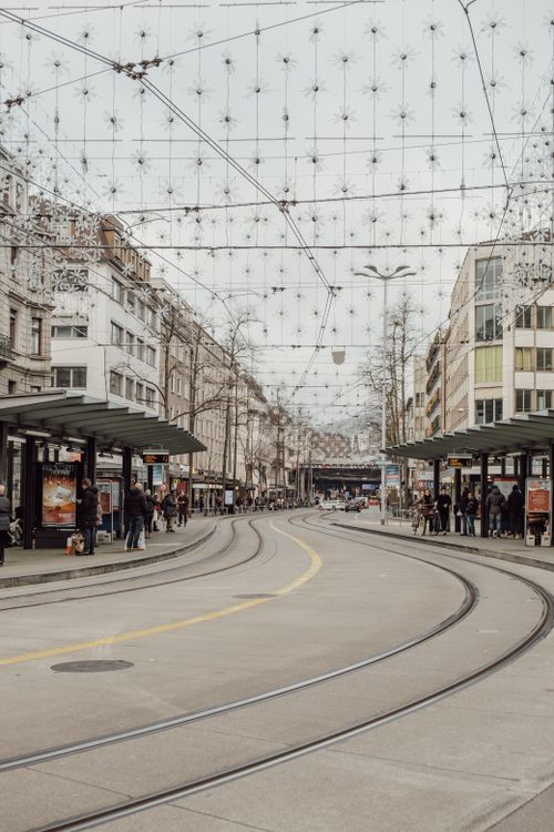 Free Bustling tram stop in central Zurich, showcasing urban life with a winter backdrop. Stock Photo