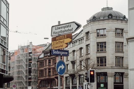 Explore Zurich's urban charm with detailed signage and architecture in this city scene.