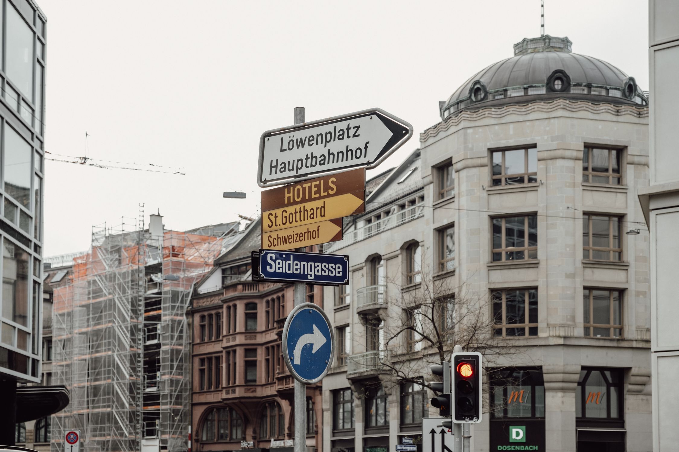 Explore Zurich's urban charm with detailed signage and architecture in this city scene.