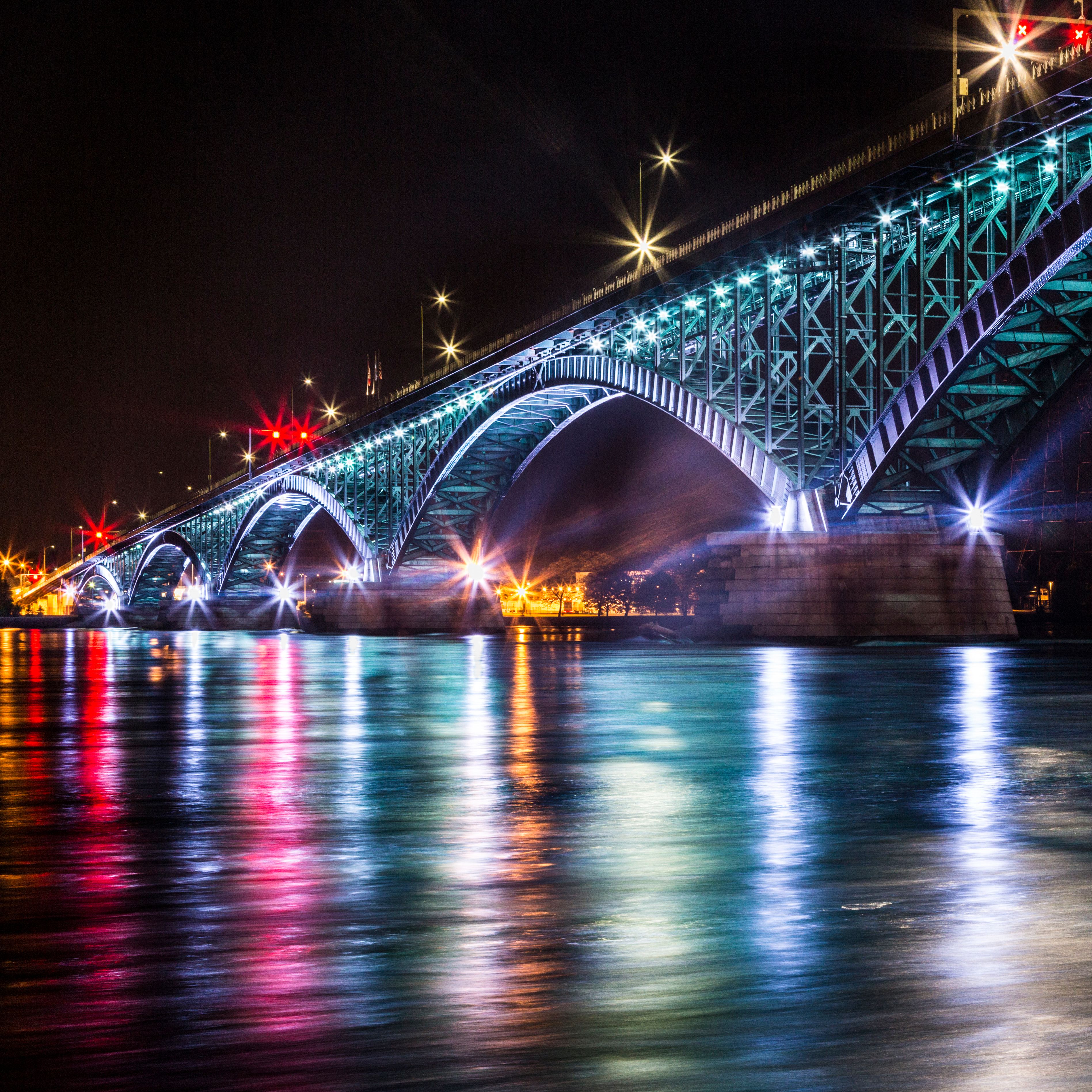 The bridge is lit up with colorful lights · Free Stock Photo