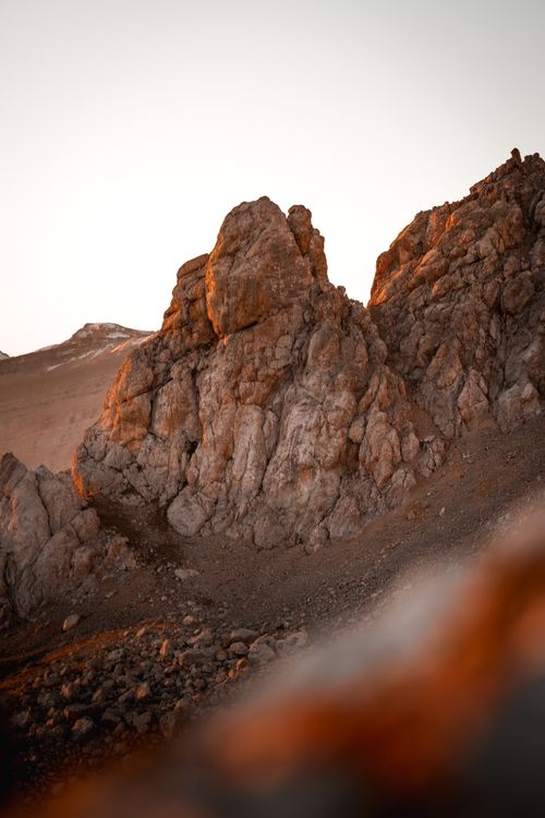 Free Dramatic rocky landscape with warm sunset hues casting shadows. Stock Photo