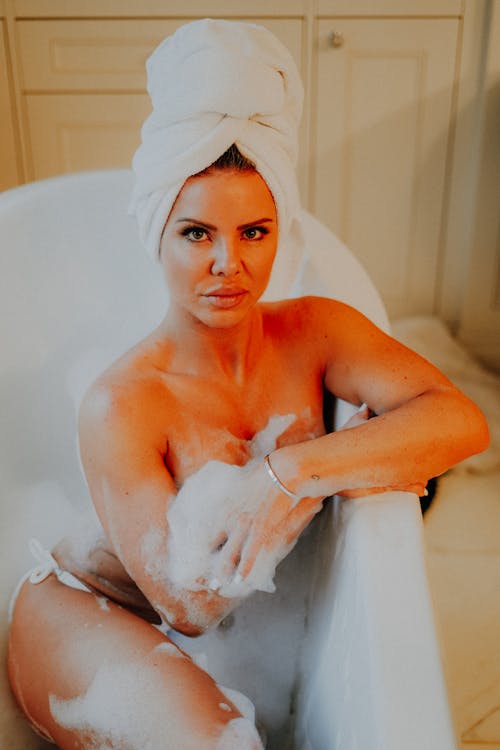 Sexy Naked Woman Sitting in Foam in Bathtub
