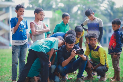 Boys and Photographer Taking Picture with Camera 