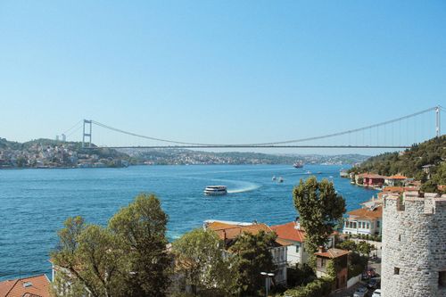 Free A panoramic view of Istanbul's Bosphorus with a prominent suspension bridge and coastal houses. Stock Photo