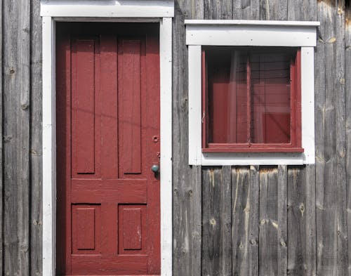 Red Door and Window in an Old Wooden House 