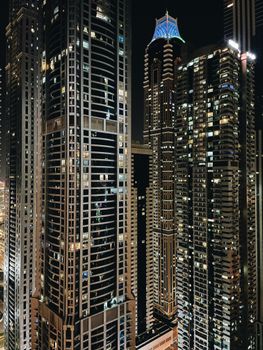 Mesmerizing night cityscape of Dubai with illuminated skyscrapers showcasing modern architecture.