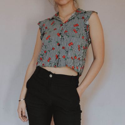 Printed blouse worn with black trousers — photo by Bianca on Pexels