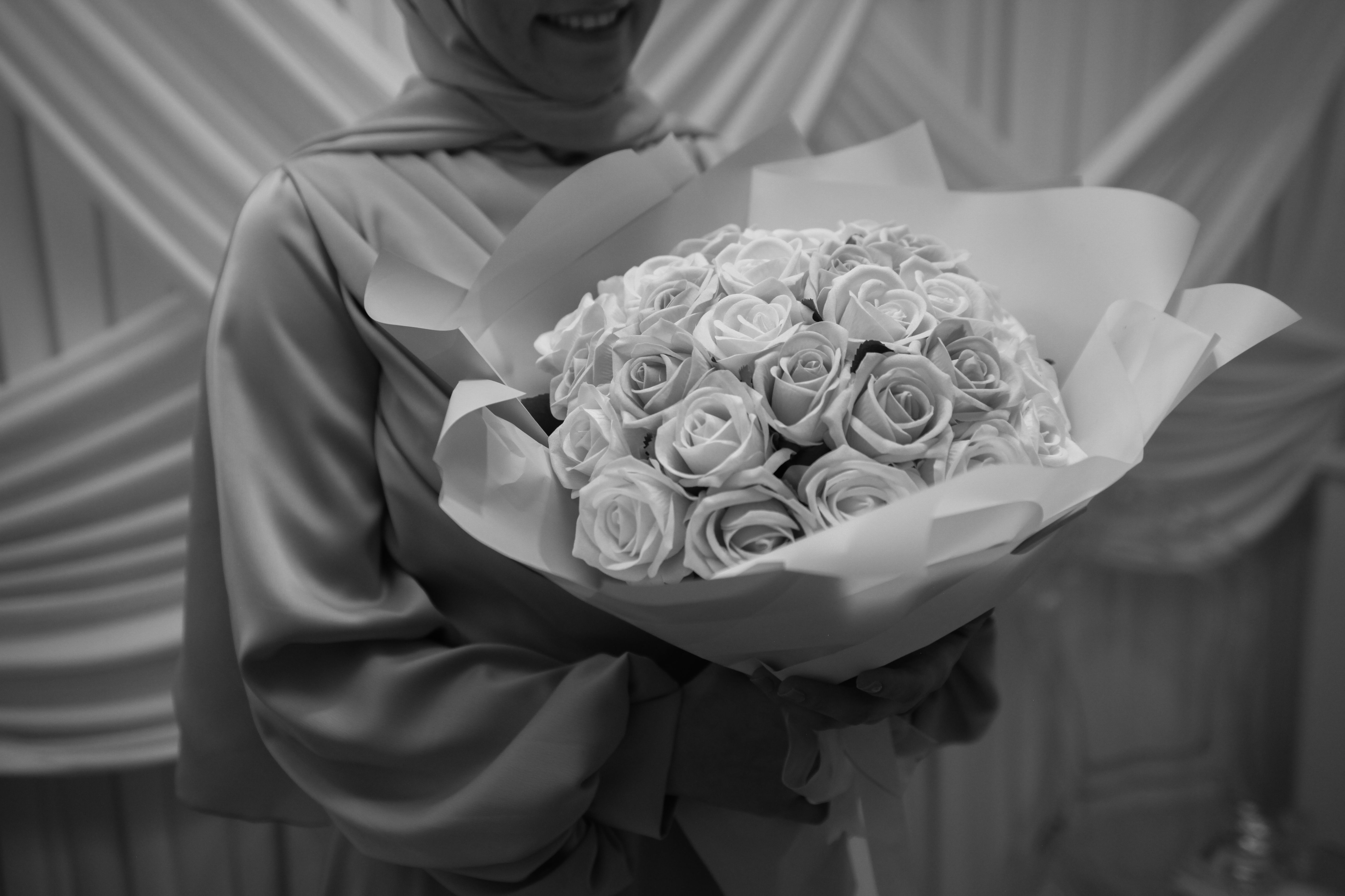 Woman Holding a Bouquet of Roses in Black and White · Free Stock Photo