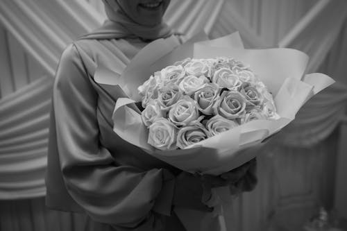 Woman Holding a Bouquet of Roses in Black and White 