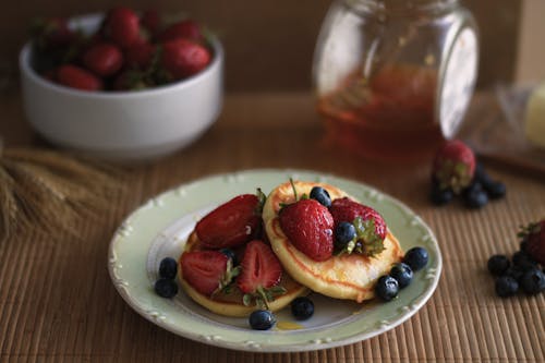 Free Close-up of Pancakes with Fruit on a White Plate Stock Photo