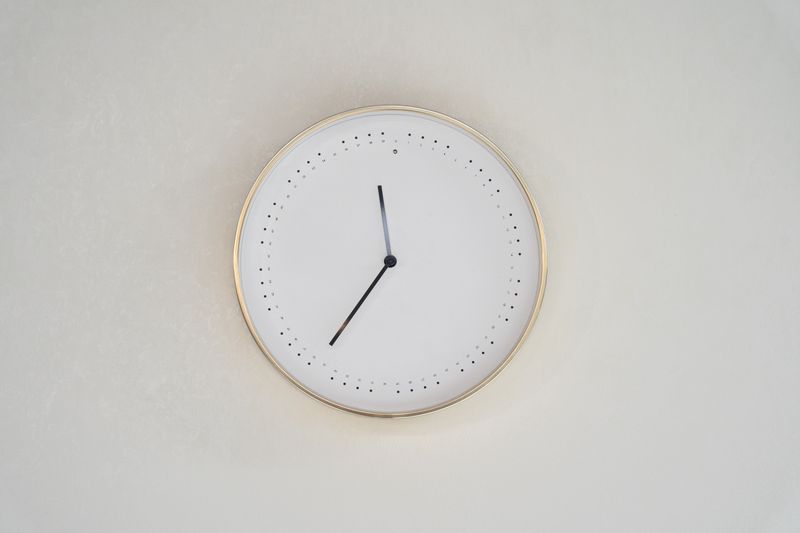 Minimalist wall clock with a gold rim