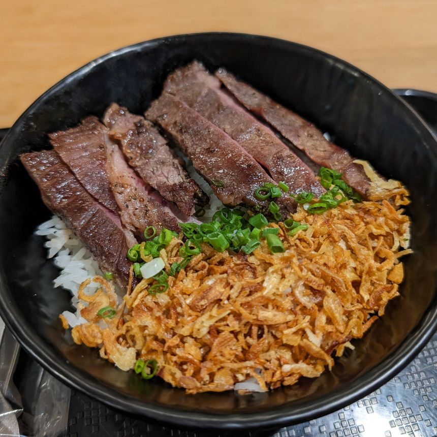 Sliced beef over rice with crisp shallot and scallion — photo by Markus Winkler on Pexels