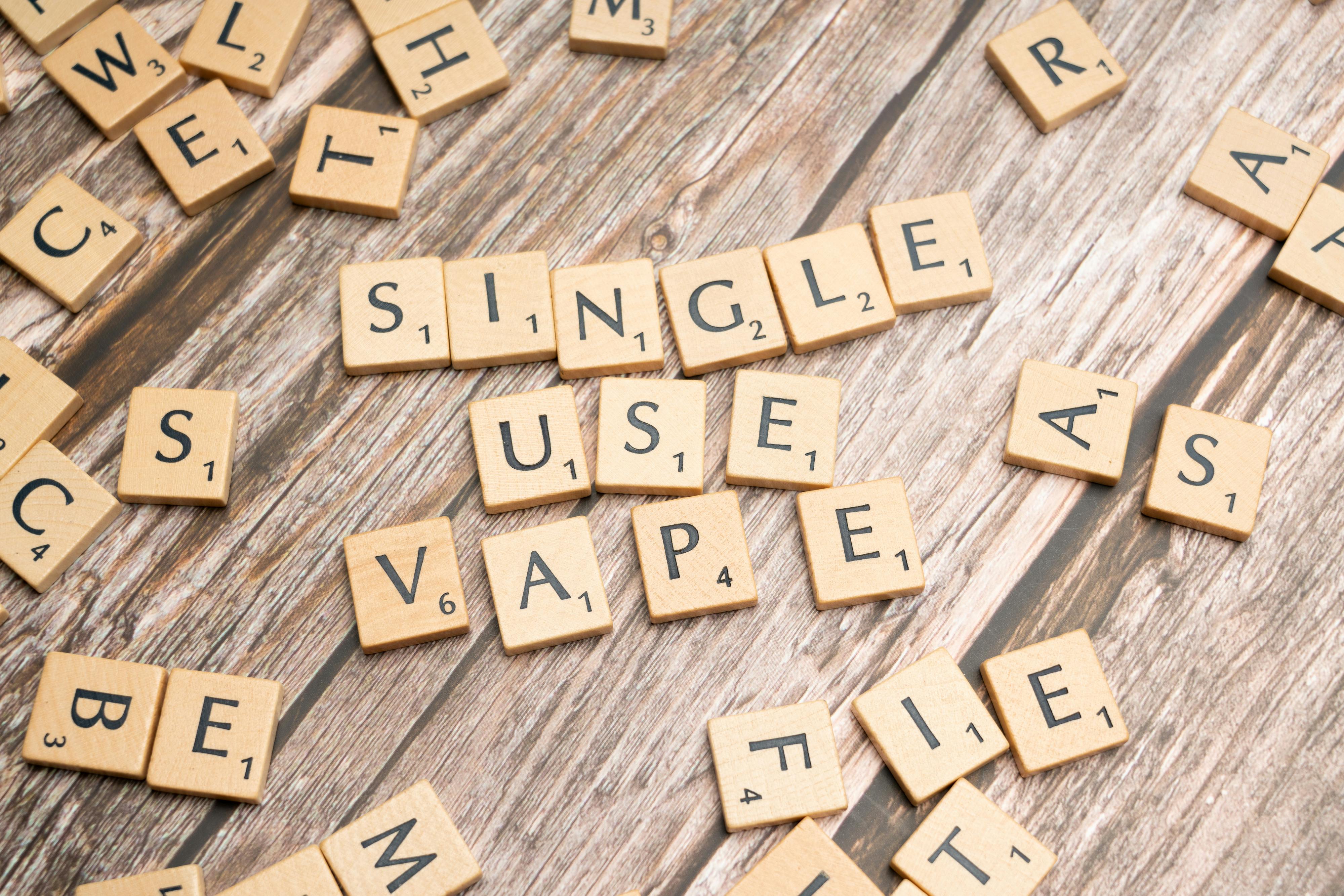 the word single use vape is spelled out on wooden blocks