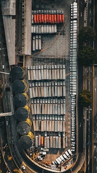 Bird's-eye view of an industrial area with neatly parked trucks, showcasing organization and infrastructure.