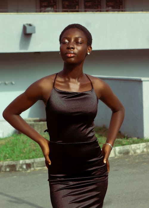 Young Woman in a Satin Dress Posing in Sunlight 