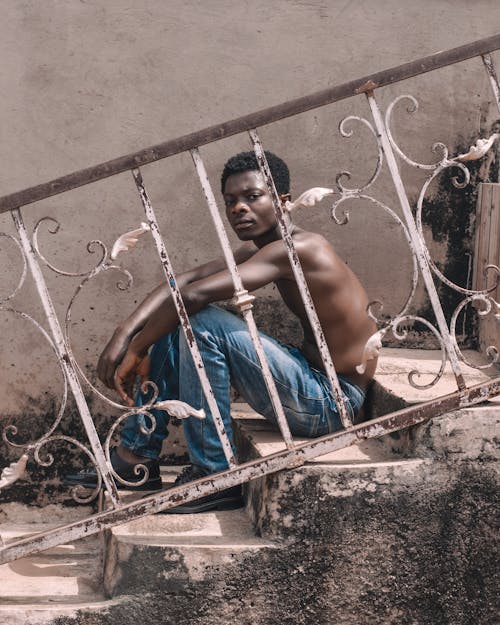 Portrait of a Shirtless Man Sitting on Steps