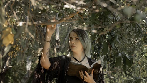 Pagan Woman Touching a Tree Branch