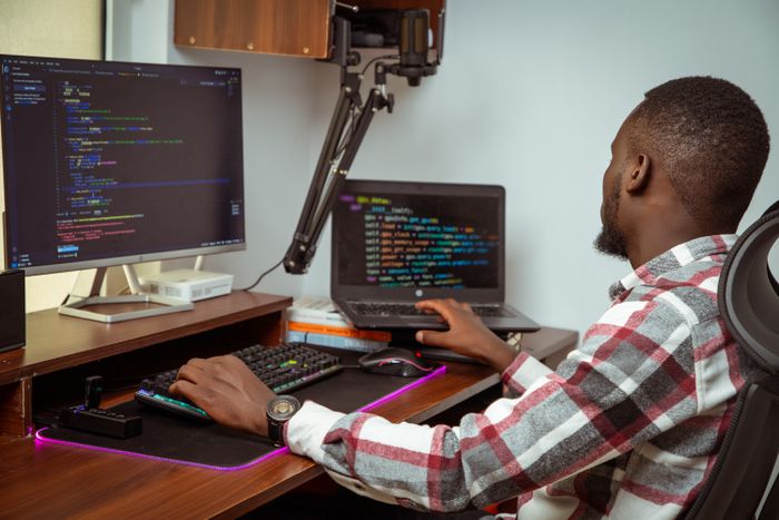Software engineer coding at a desktop in a Nairobi office