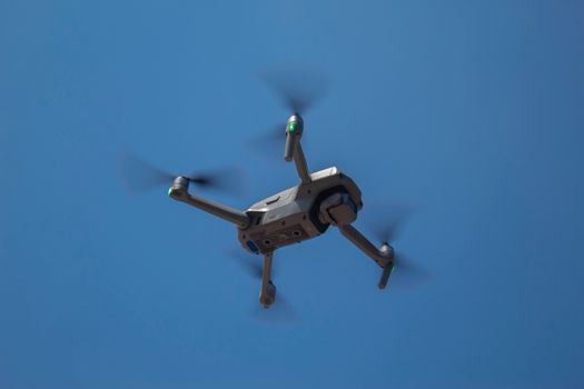 A drone flying against a clear blue sky in Santiago de Querétaro, Mexico.